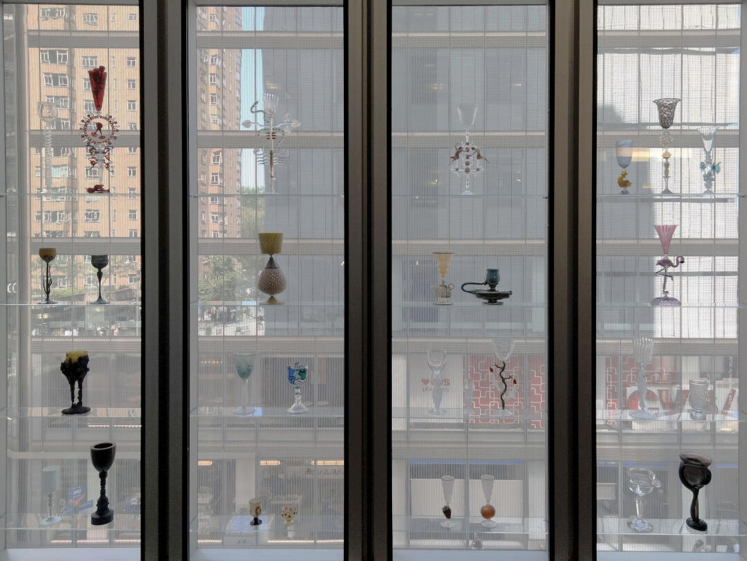 Photo of a variety of glass sculptures on a window display.