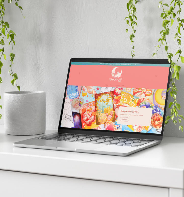 Mockup of Marshmayo Art's shop on a laptop.